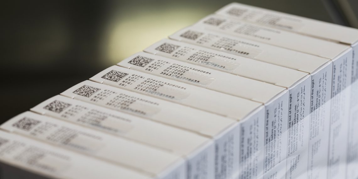 Gebündelte Medikamentenverpackungen mit Data Matrix Code und fünfzeiligem Klarschriftaufdruck.
